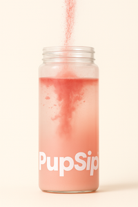 Pink drink in a jar labeled 'PupSip' with a straw on a light pink background